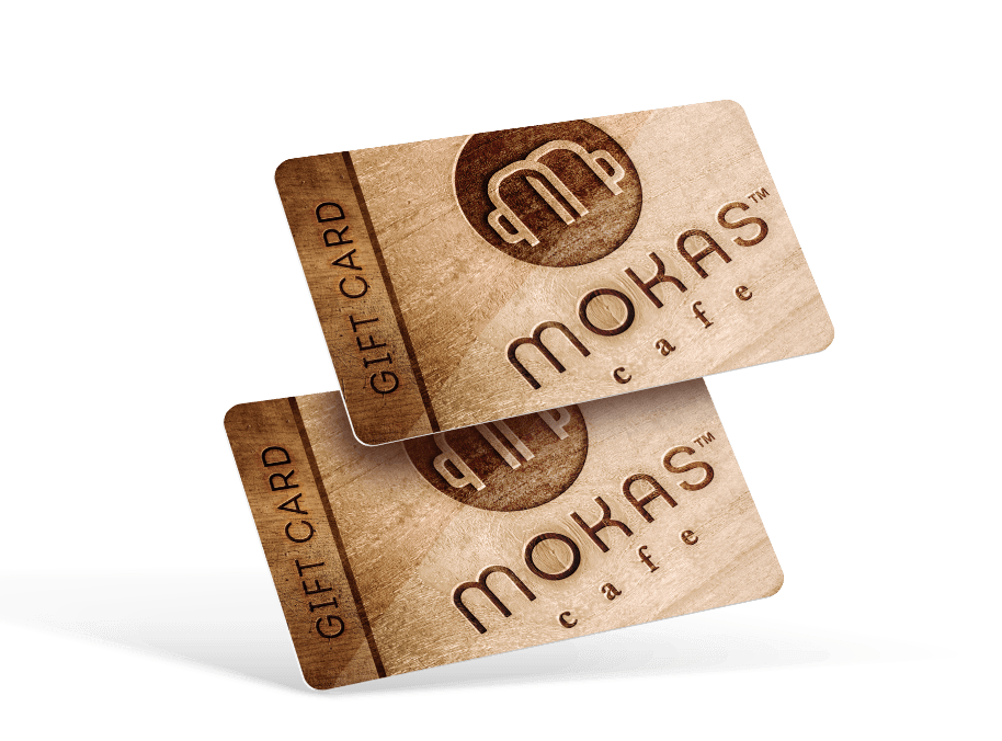 Two gift card, with faux wood design, and the Mokas logo across the card.