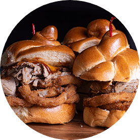 Three challah rolls filled withBBQ brisket, Cheddar cheese, and crispy onion strings.