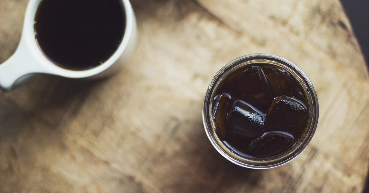 A glass of cold brew coffee sitting on a table