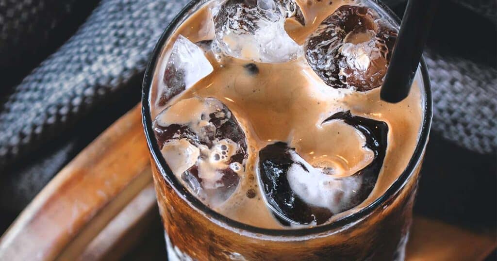 Coffee with cream in a glass with ice with aerial view